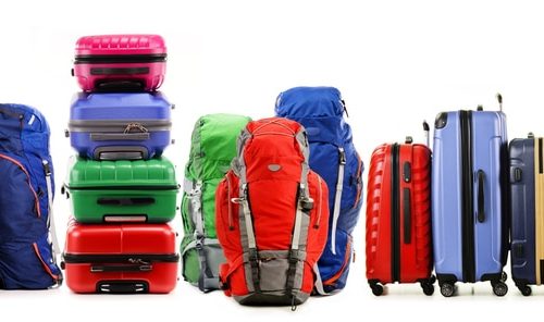 Luggage consisting of large suitcases and backpacks isolated on white.